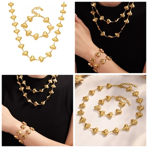 Detail view of 18k gold plated stainless steel hollow heart necklace and bracelet set
