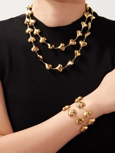 Detail view of 18k gold plated stainless steel hollow heart necklace and bracelet set