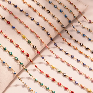 Colorful evil eye necklaces in gold finish arranged neatly on a white display cushion