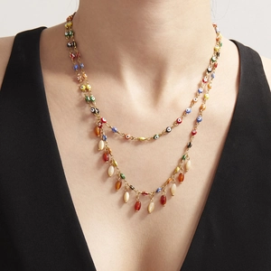 Golden double-layer Evil Eye necklace with colorful beads worn by a model