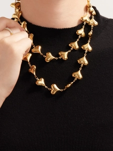 Close-up of polished 18k gold plated stainless steel puffed heart charm necklace