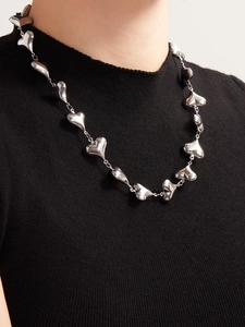 Close-up of polished stainless steel hollow heart links on the necklace chain