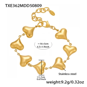 Detail view of 18k gold plated stainless steel bracelet with hollow heart charms