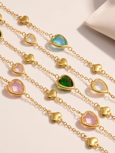 Close-up of 18k gold plated heart necklace with colorful faceted crystal stones