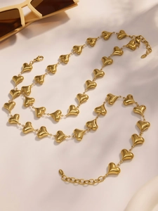 Macro shot of 18k gold plated hollow heart charm necklace with lobster clasp detail