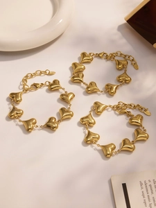 Close-up of 18k gold plated stainless steel hollow heart bracelets with lobster clasp