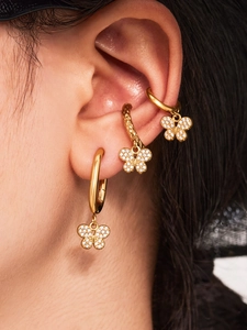 Gros plan sur les créoles et ear cuffs papillon plaqués or 18k avec zircons brillants
