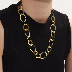 Collier à grosses mailles en acier inoxydable doré porté par un mannequin de mode