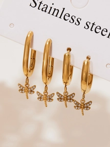 Macro detail of gold dragonfly earrings with micro-pave crystals on stainless steel