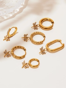 Close-up of gold-plated dragonfly drop earrings set with shimmering cubic zirconia