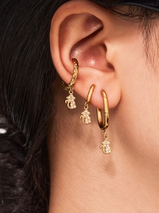 Detailed view of 18k gold plated bear earrings with sparkling 5A zircon inlay on ear
