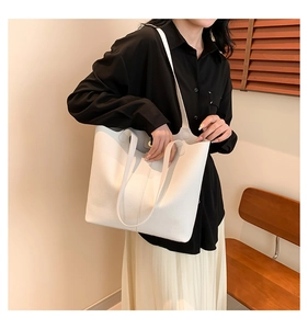 Detailed view of white lychee texture tote bag featuring soft leather and magnetic closure