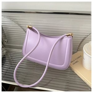 Detail view of a light purple PU leather crescent bag on a textured wave stand