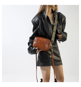 Brown vintage faux leather crossbody bag with V-quilted texture and ethnic woven strap