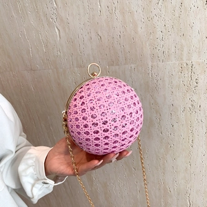 Pink spherical evening clutch bag with woven texture and sparkling pink crystals