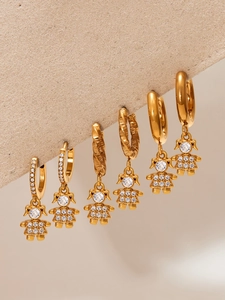 Detailed view of gold bear earrings featuring 5A cubic zirconia and textured hoop styles
