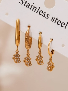 Close-up of four 18k gold plated stainless steel cat earrings with sparkling cubic zirconia