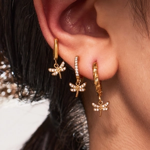 Three-piece gold dragonfly earrings set with micro-p鑲 zircorn gemstones on model's ear