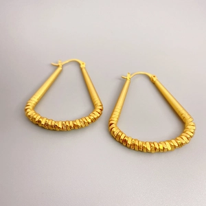 Golden brass triangle earrings with textured wrap design and 18K gold plating finish