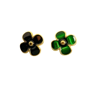 Golden 18K plated flower earrings with black and green enamel finish on white background