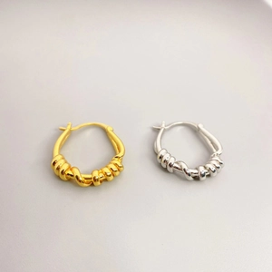 Minimalist twisted rope hoop earrings in polished gold and silver plated brass finish
