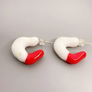 Minimalist red and white enamel C-shaped brass earrings with sleek irregular curves