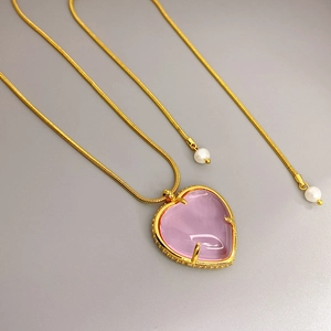 Pink heart crystal pendant necklace with gold snake chain and pearl accents