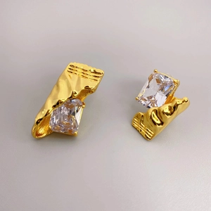 Irregular gold-tone candy wrap stud earrings with large rectangular crystal stones