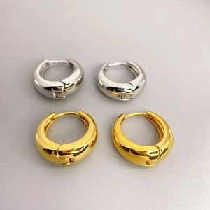Chunky polished gold and silver hoop earrings in minimalist thick cocoon shape design