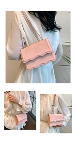 Detail showing pink suede wavy flap bag with chain strap and embossed logo texture