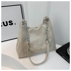 Detailed macro view of the matte faux leather texture and silver chain strap on a tote bag