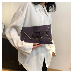 Deep purple crocodile textured envelope clutch bag with elegant gold metal buckle detail