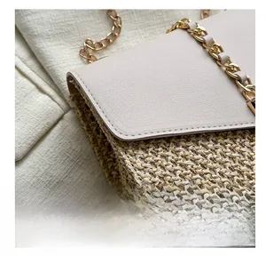 Detail view showing precision stitching on straw crossbody bag with cream leather flap