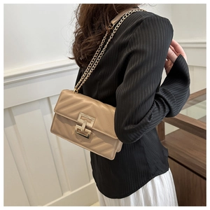 Quilted leather crossbody bag in beige with V-stitch patterns and gold geometric lock