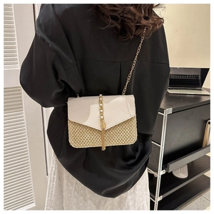 Women's straw woven crossbody bag with cream leather flap and gold chain strap