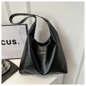 Detail of black textured tote bag featuring a minimalist Fashion & Bags square logo