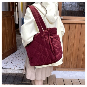 Quilted burgundy nylon tote bag with rhombus pattern showing large capacity and shoulder strap