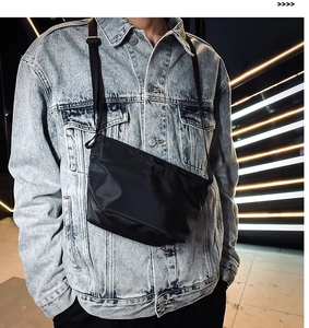 Primer plano de bandolera de nailon negro en un modelo con chaqueta vaquera