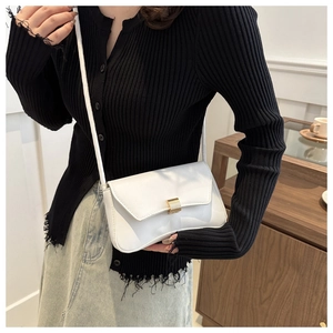 Detailed side view of a white rectangular crossbody bag with golden metal clasp hardware