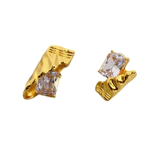 Golden candy-shaped studs with rectangular crystals and irregular wrinkled metal texture