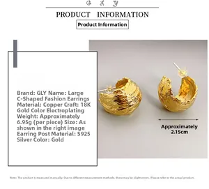 Detail of C-shaped gold earrings showing irregular lava texture and S925 silver pins