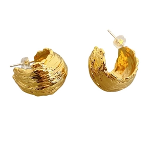 Chic gold-plated C-shaped earrings with irregular textured surface and vintage design