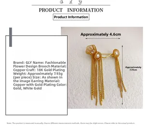 Detail of flower brooch with pearls and long tassels in 18K gold plated copper finish