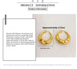 Detail of 18K gold-plated C-shaped earrings with red gemstones and irregular texture