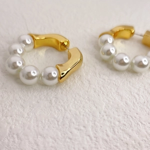 Elegant gold beaded hoop earrings featuring polished white faux pearls for women