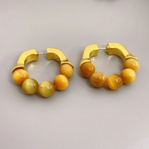 Gold-plated hoop earrings featuring natural tiger eye beads and minimalist retro design