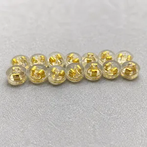 Macro shot of 14 transparent silicone earring backs with premium gold metal inner cores