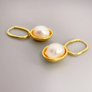 Vintage gold hoop earrings featuring irregular baroque pearls with natural luster