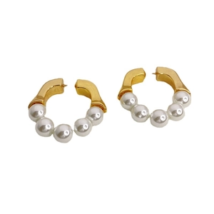 Modern gold hoop earrings featuring five white pearls on a clean white background