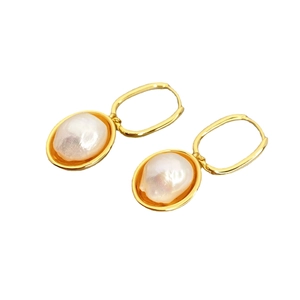 Vintage gold U-shaped hoop earrings with baroque pearls on a clean white background